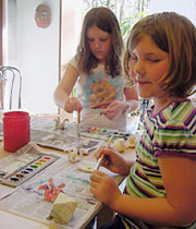 two girls painting at table
